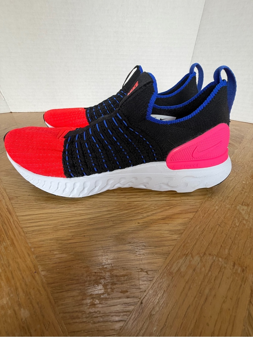 Nike women’s Slip-On Sneakers in Black, Red & Pink
